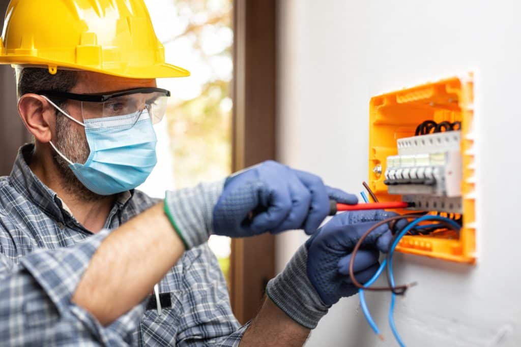 Electrician at electrical panel