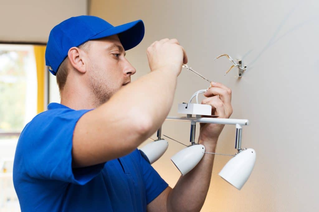 electrician installing lamp